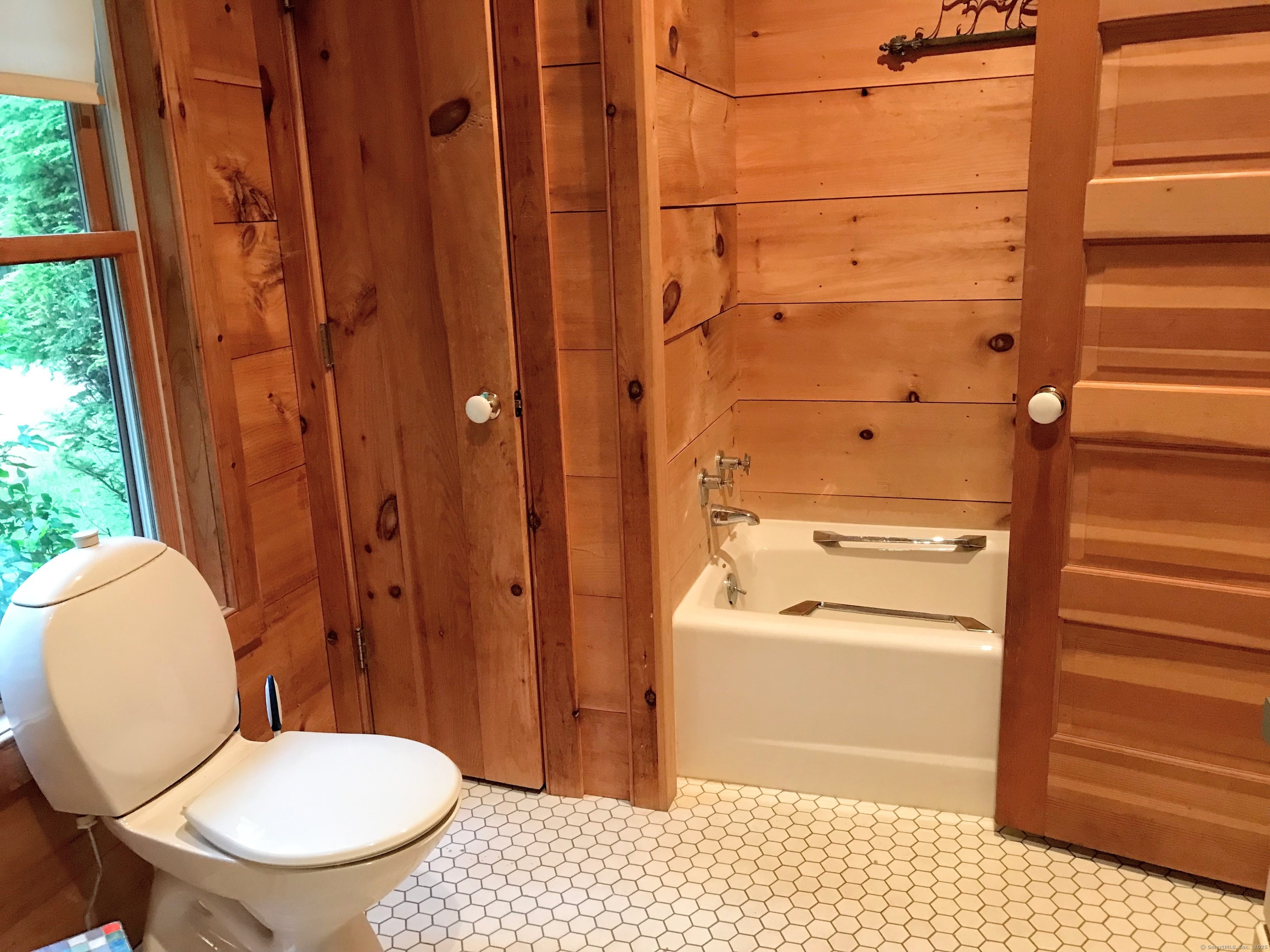 310 Twin Lakes Road Salisbury, CT 06068 - Photo 15 of 31 a bathroom with a toilet a sink and a window