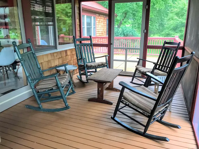 a view of a patio with wooden floor and outdoor seating
