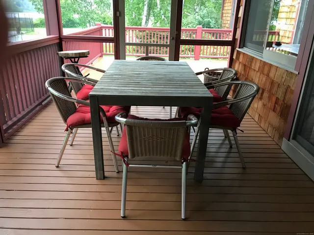 a view of a patio with table and chairs with wooden floor