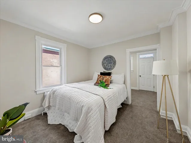 a bedroom with bed and window