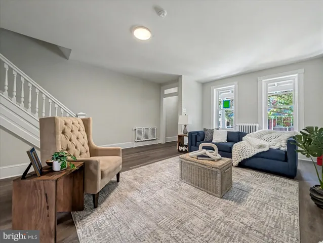 a living room with furniture and a potted plant