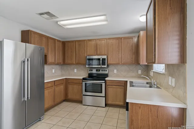 a kitchen with a sink a stove and refrigerator