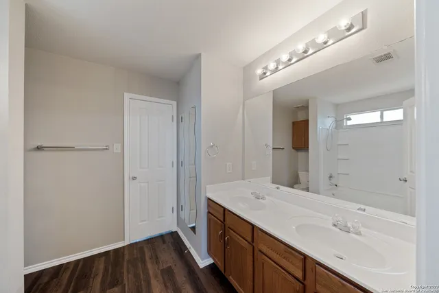 a spacious bathroom with a double vanity sink and a mirror