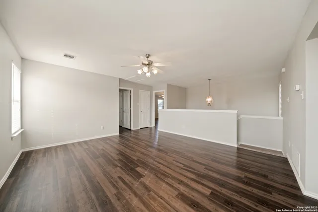 a view of an empty room and wooden floor