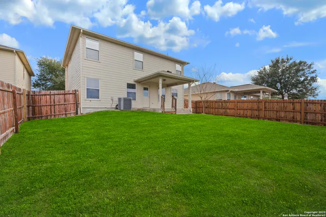 a view of a house with a yard and porch