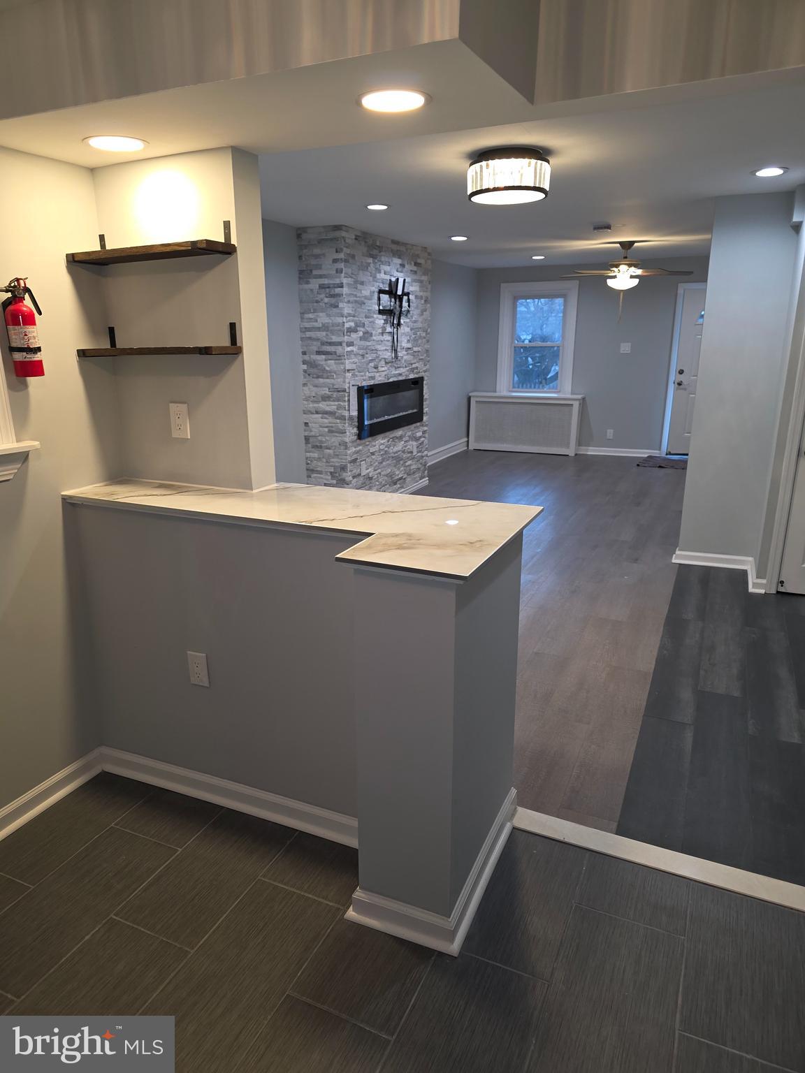 86 Houston Road Lansdowne, PA 19050 - Photo 7 of 17 an empty room with wooden floor and kitchen view