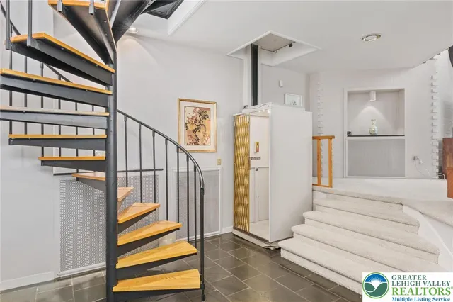 a living room with furniture a rug and a window