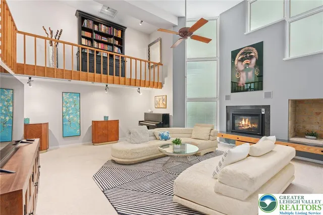 a living room with furniture a rug and a chandelier