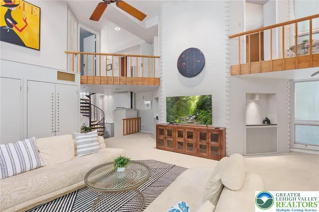 a view of a bedroom with furniture and window