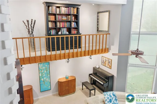 a living room with fireplace furniture and a large window