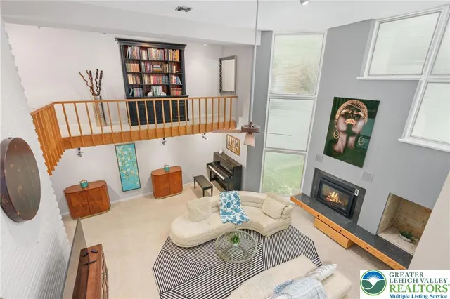 a living room with furniture a rug and a painting on the wall