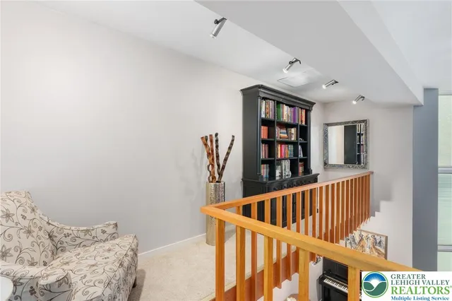 a living room with furniture a rug and white walls