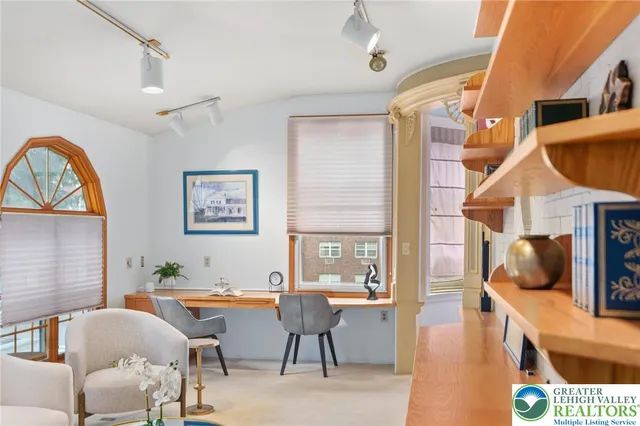 a living room with furniture gym equipment and a chandelier