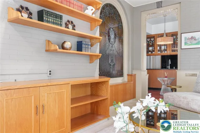 a living room with furniture a rug and a window