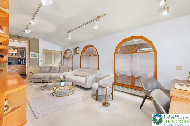 a view of a bedroom with furniture and windows