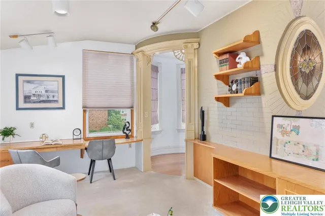 a living room with furniture and kitchen view