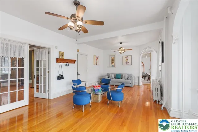 a spacious bedroom with a large bed and a chandelier