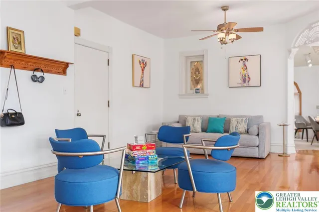 a living room with furniture and a chandelier