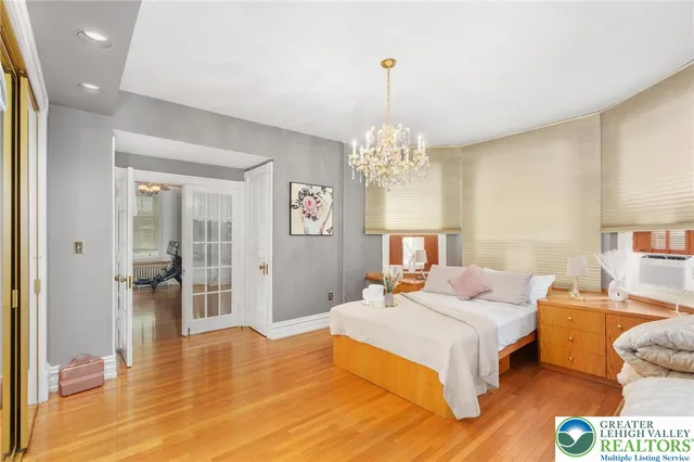 a kitchen with stainless steel appliances granite countertop a refrigerator a stove and a sink with wooden floor