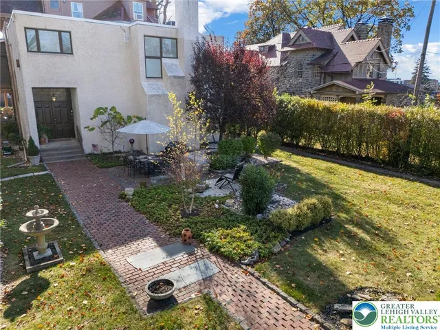 a view of a chairs and table in a backyard