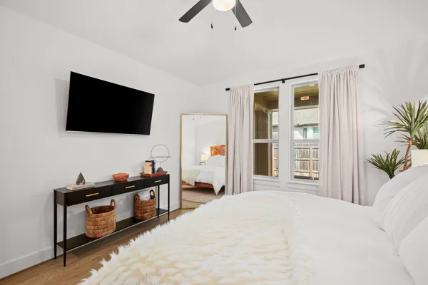a bedroom with a bed and ceiling fan