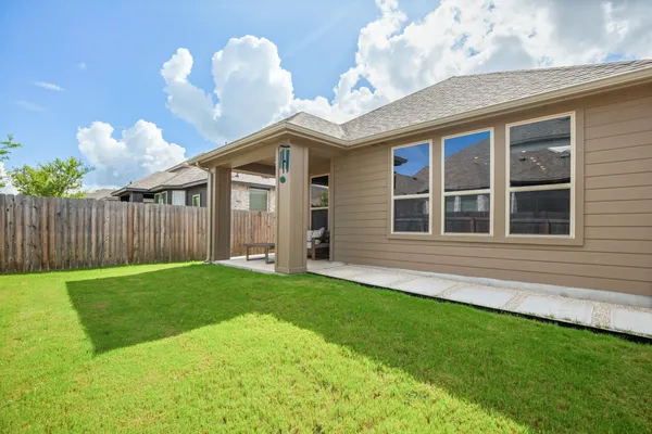 a view of an house with backyard porch and sitting area