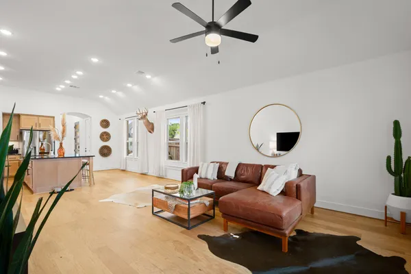 a living room with furniture and a wooden floor