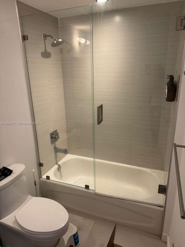 1010 Southwest 2nd Avenue, Unit 1502 Miami, FL 33130 - Photo 13 of 19 a white toilet and tub sitting next to a bathroom sink