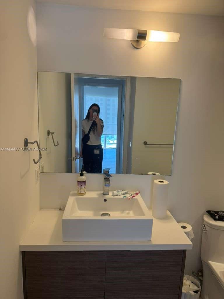 1010 Southwest 2nd Avenue, Unit 1502 Miami, FL 33130 - Photo 14 of 19 a bathroom with a sink and a mirror