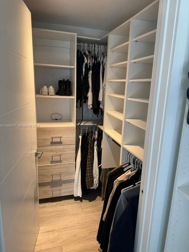 1010 Southwest 2nd Avenue, Unit 1502 Miami, FL 33130 - Photo 15 of 19 a view of walk in closet with clothes and shoes