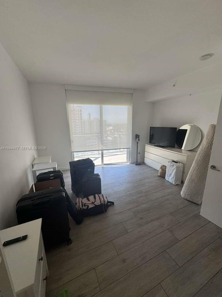 1010 Southwest 2nd Avenue, Unit 1502 Miami, FL 33130 - Photo 16 of 19 a bedroom with furniture and wooden floor
