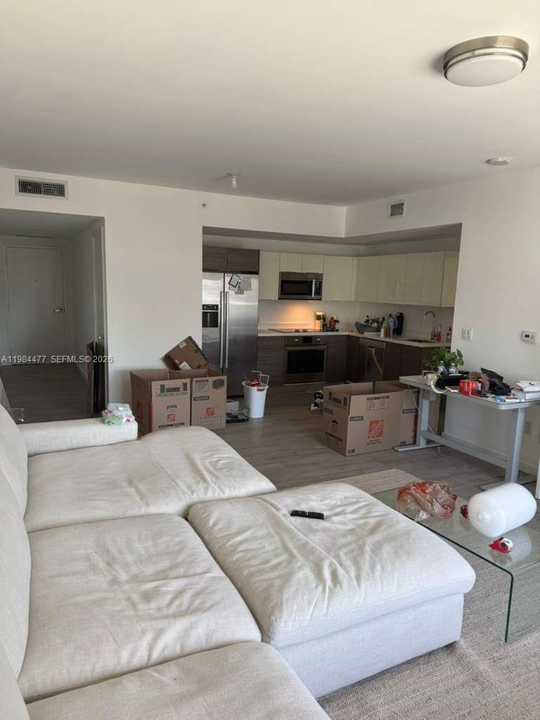 1010 Southwest 2nd Avenue, Unit 1502 Miami, FL 33130 - Photo 18 of 19 a living room with furniture kitchen view and a window