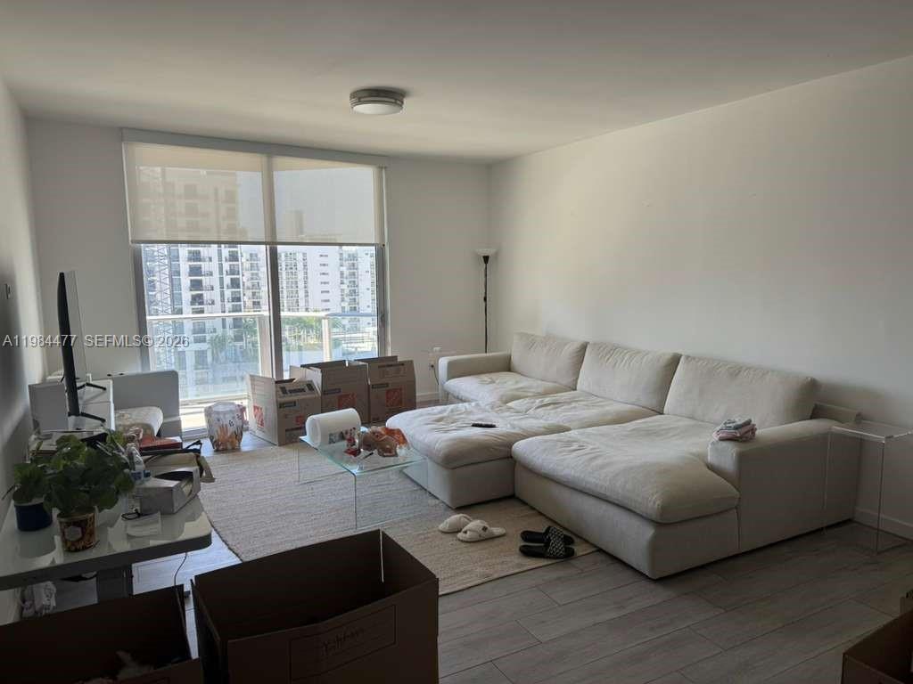 1010 Southwest 2nd Avenue, Unit 1502 Miami, FL 33130 - Photo 4 of 19 a living room with furniture and a flat screen tv