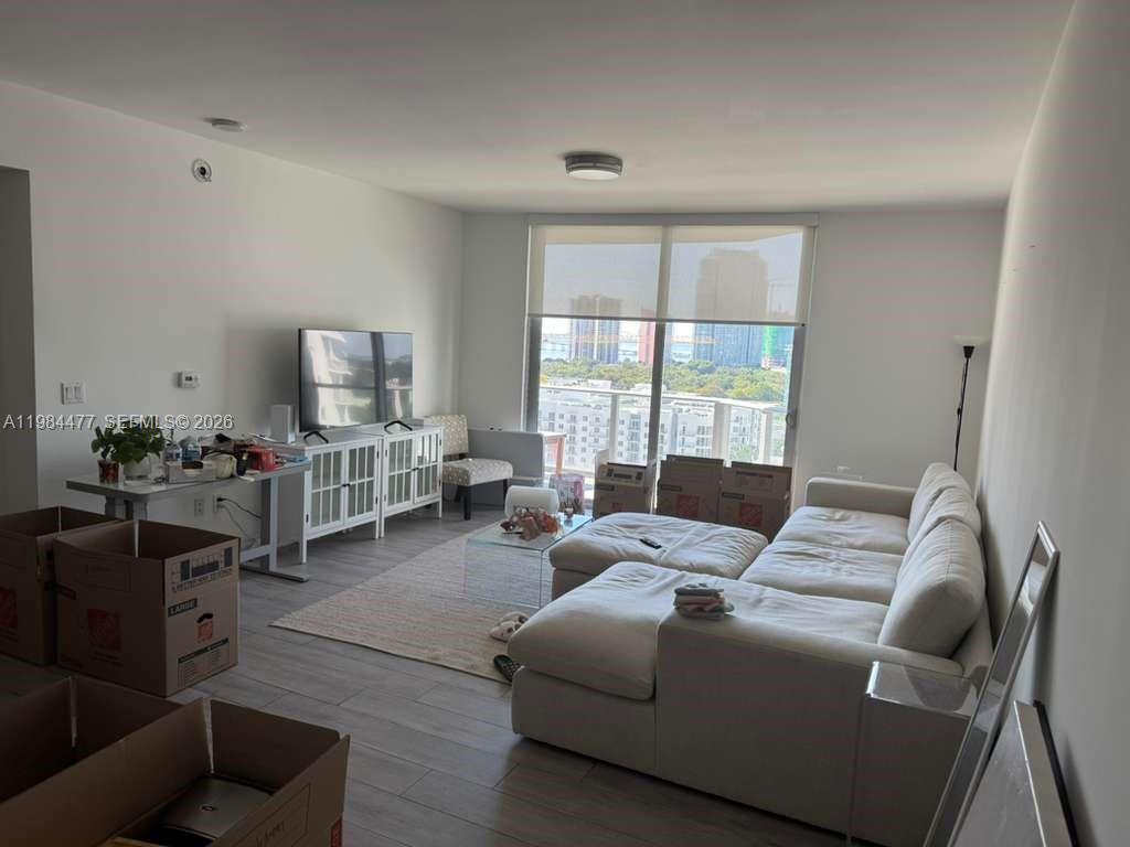 1010 Southwest 2nd Avenue, Unit 1502 Miami, FL 33130 - Photo 5 of 19 a living room with furniture and a flat screen tv