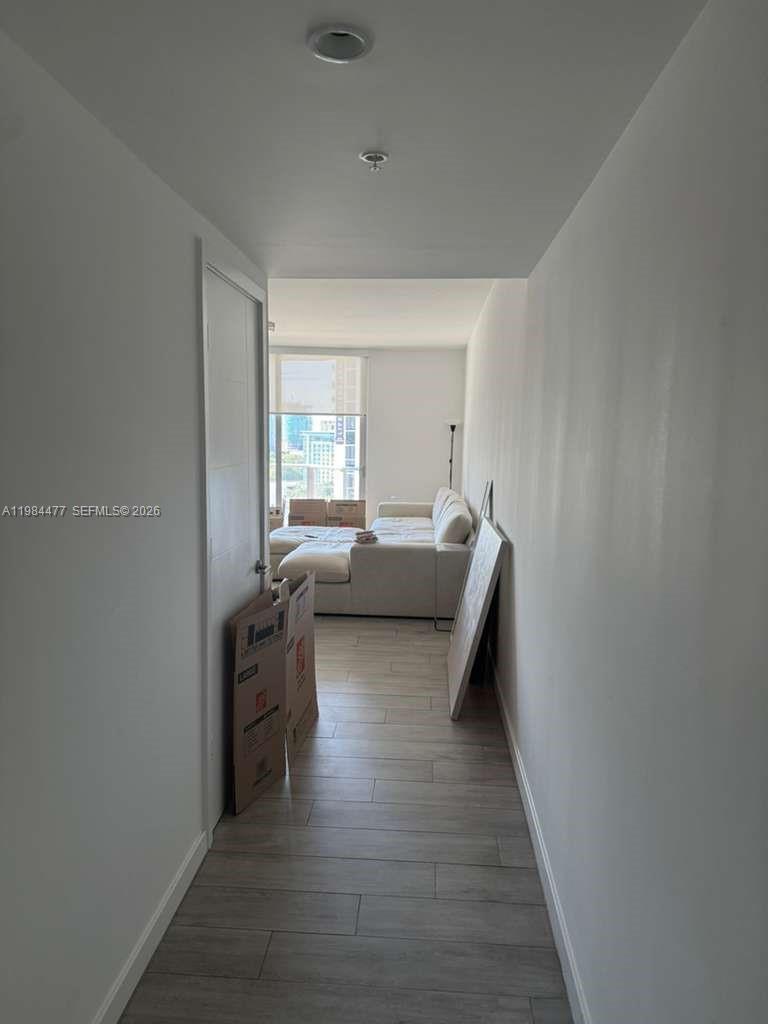 1010 Southwest 2nd Avenue, Unit 1502 Miami, FL 33130 - Photo 7 of 19 a living room with furniture and a wooden floor