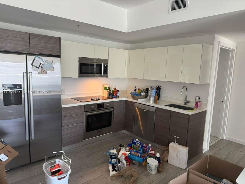 1010 Southwest 2nd Avenue, Unit 1502 Miami, FL 33130 - Photo 8 of 19 a kitchen with a sink and refrigerator