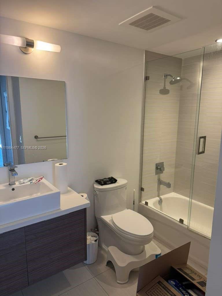 1010 Southwest 2nd Avenue, Unit 1502 Miami, FL 33130 - Photo 9 of 19 a bathroom with a sink a toilet and shower
