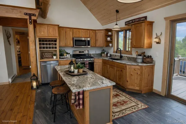 a kitchen with a stove a sink and a refrigerator