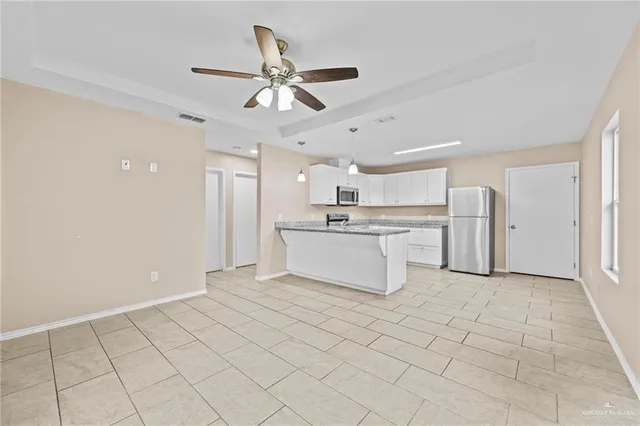 a view of a kitchen with a sink and a refrigerator