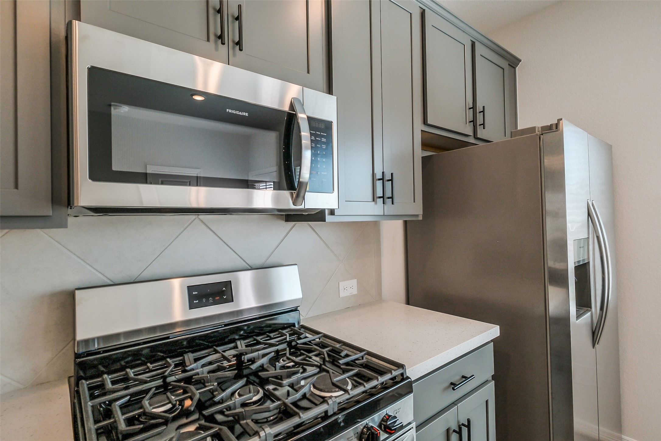 6411 Paris Street Houston, TX 77021 - Photo 14 of 33 a kitchen with stainless steel appliances a stove a microwave and a refrigerator