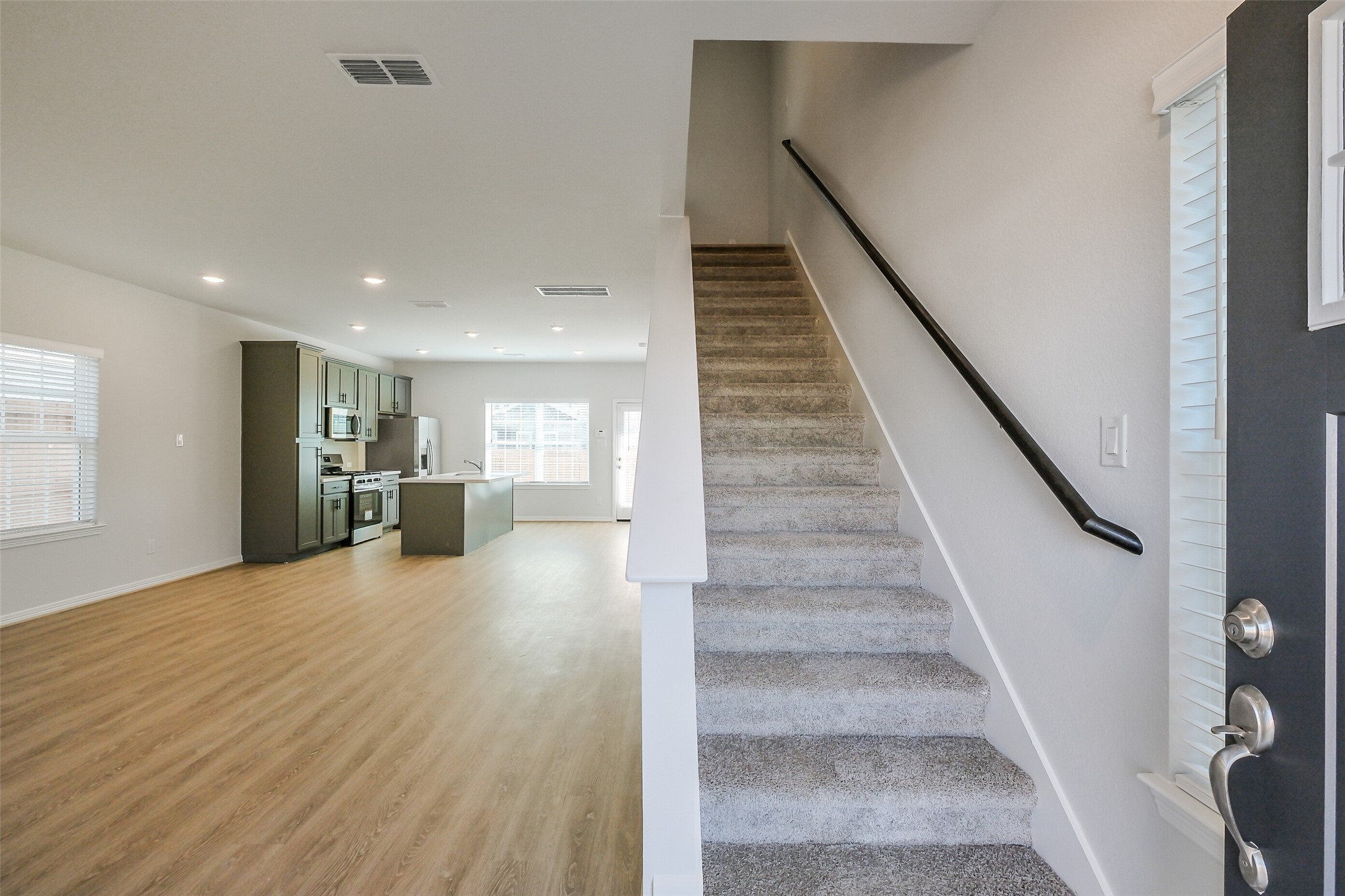 6411 Paris Street Houston, TX 77021 - Photo 6 of 33 a view of a hallway with wooden floor and staircase