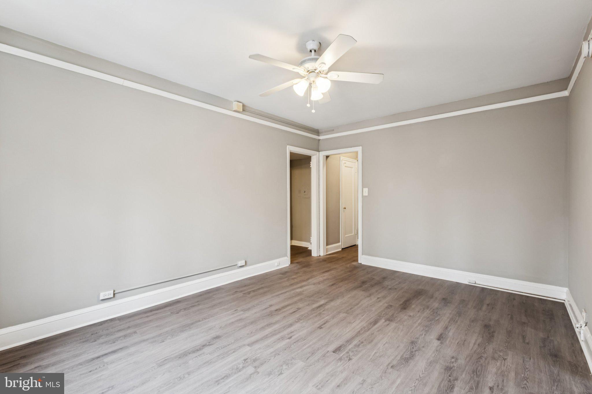 2031 Locust Street, Unit 504 Philadelphia, PA 19103 - Photo 2 of 14 an empty room with wooden floor and fan