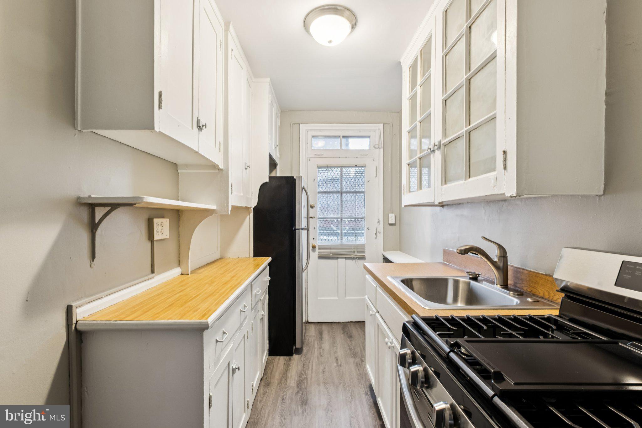 2031 Locust Street, Unit 504 Philadelphia, PA 19103 - Photo 3 of 14 a kitchen with a stove and a sink