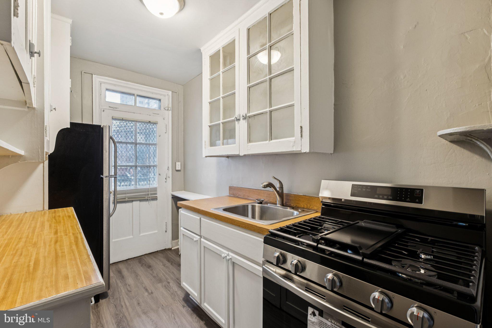2031 Locust Street, Unit 504 Philadelphia, PA 19103 - Photo 4 of 14 a kitchen with a stove and a refrigerator
