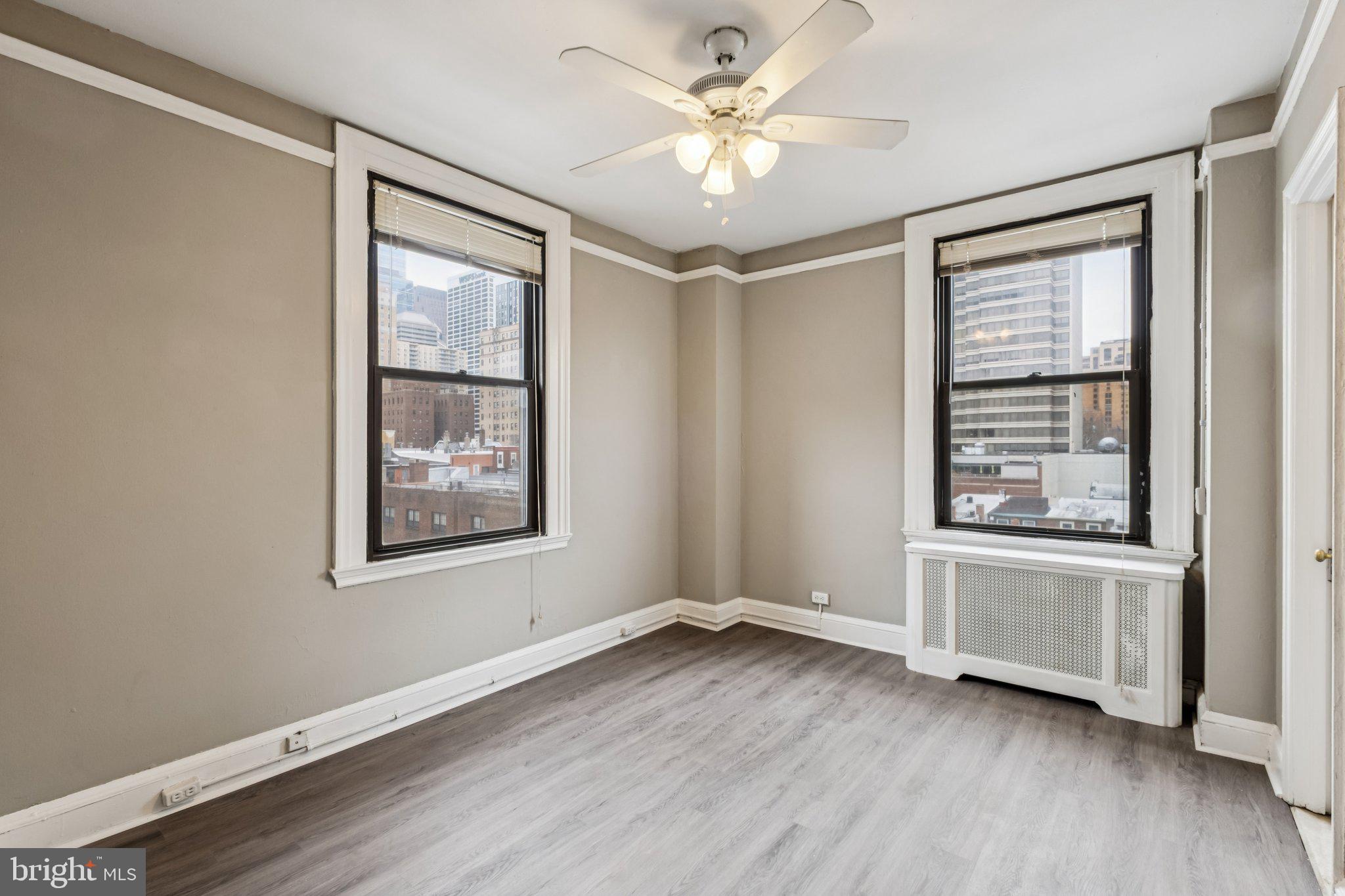 2031 Locust Street, Unit 504 Philadelphia, PA 19103 - Photo 7 of 14 wooden floor in an empty room with a window