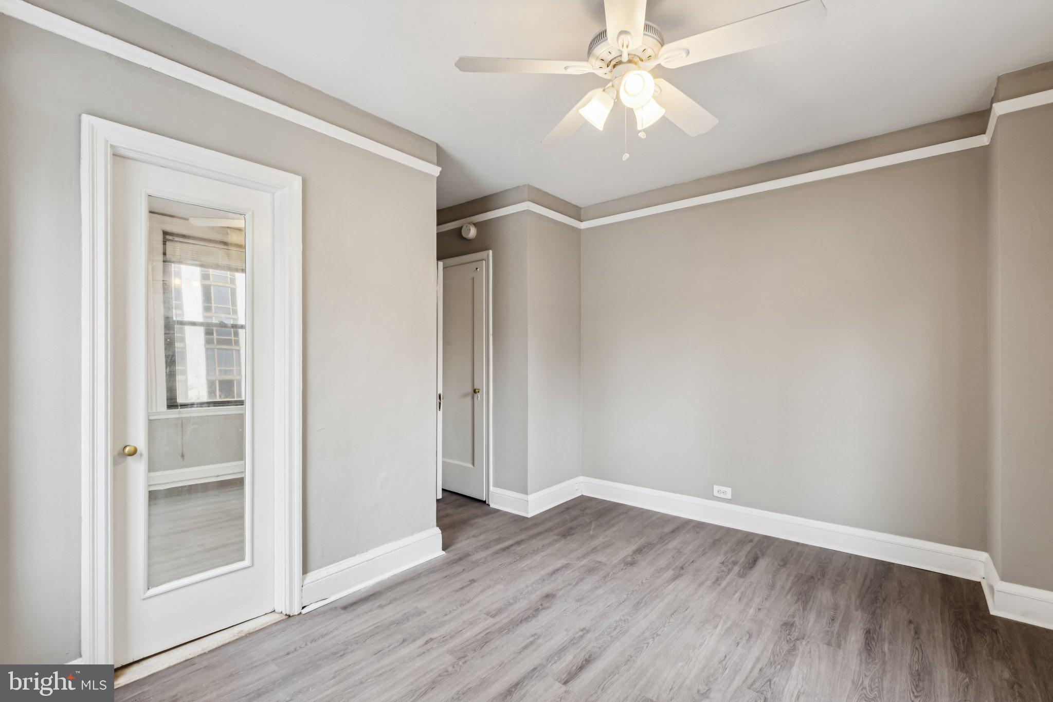 2031 Locust Street, Unit 504 Philadelphia, PA 19103 - Photo 8 of 14 wooden floor in an empty room with a window