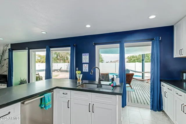 a kitchen with granite countertop a sink and a large window