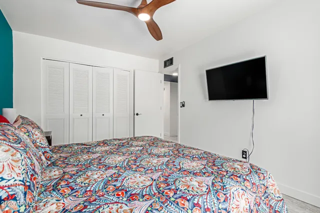 a bedroom with a bed and a flat screen tv