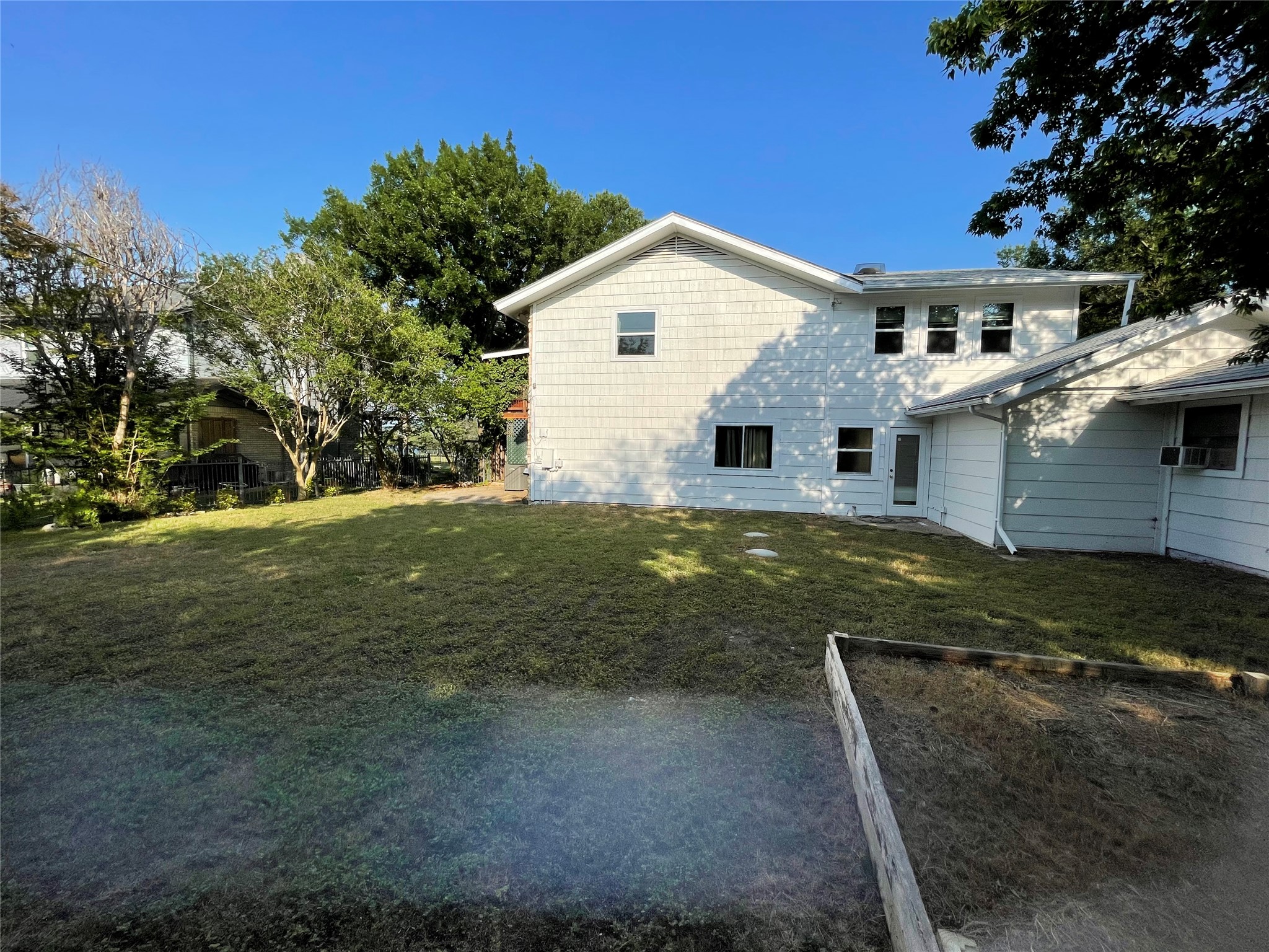 5802 Longhorn Landing Austin, TX 78734 - Photo 12 of 38 Rear view of house with a lawn