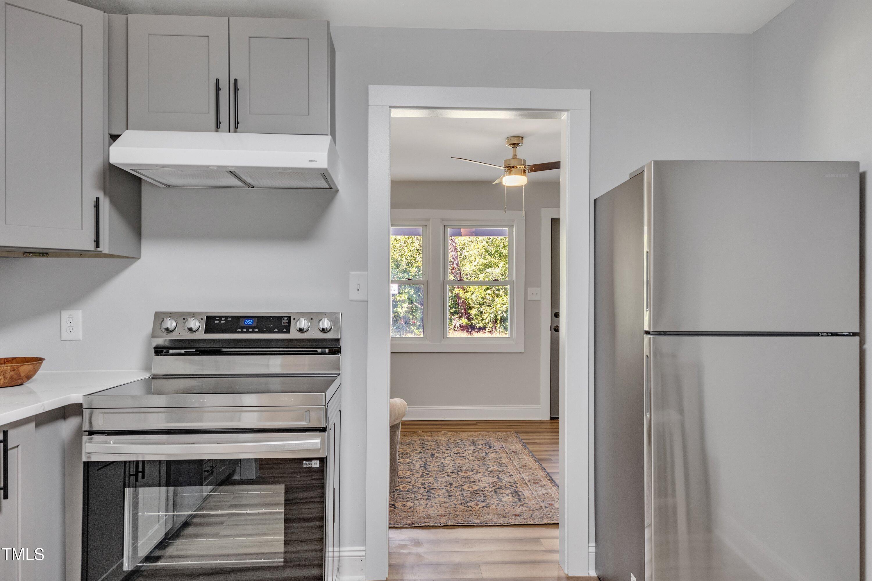 712 Bailey Drive Raleigh, NC 27610 - Photo 11 of 33 a kitchen with a stove and a refrigerator